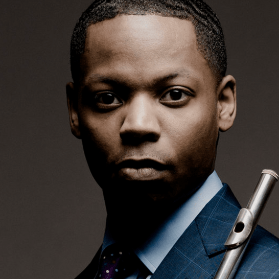 Portrait of Brandon Patrick George holding flute against his shoulder